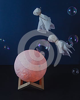 Flying ghosts in soap bubbles over the moon