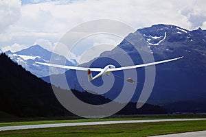 A flying glider in the alps