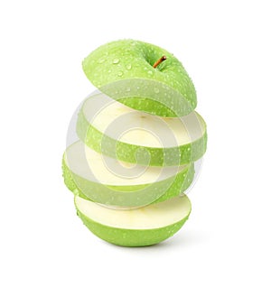 Flying green apple sliced with water droplets