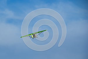 A flying hang-glider on the background of a blue sky