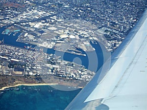 Flying into Hawaii with the ocean view and blue sky and coastline