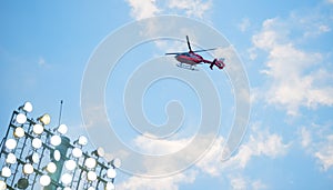 Flying helicopter over fotball spotlights photo
