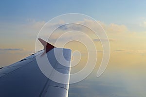 Flying High: A View from the Cabin. Wing of an airplane flying above the clouds