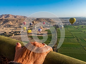 Flying on a hot air balloon.