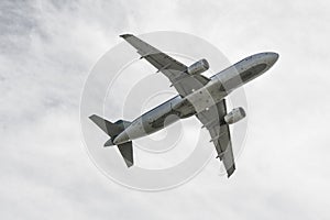 Flying jet fighter plane and a white cloudy sky