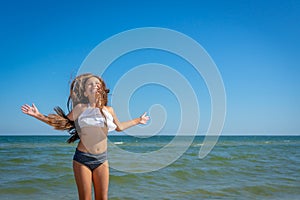 Flying jump beach little happy girl on blue sea shore in summer vacation