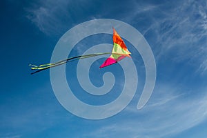 Flying a kite. Bright kite against the blue sky. Sunny day