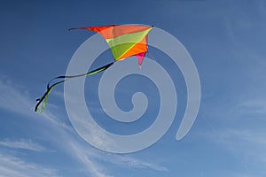 Flying a kite. Bright kite against the blue sky. Sunny day