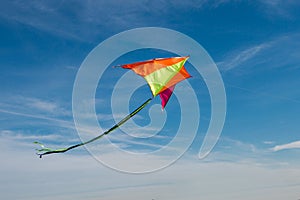 Flying a kite. Bright kite against the blue sky. Sunny day