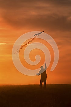 Flying a kite. Silhouette of a man with a kite against the sky. Bright sunset