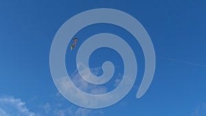 Flying kites in the blue sky and white clouds with strong winds