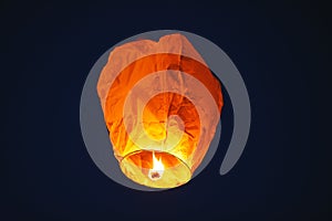 Flying lantern in the dark sky at night