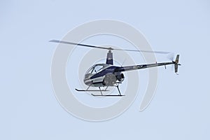 Flying little helicopter bicolor, blue and white. Robinson R22