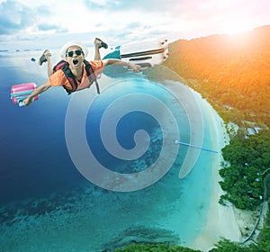 flying man happiness vacation time over beautiful blue sea traveling destination