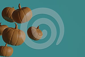 Flying Orange pumpkins on blue background, holiday decoration for Halloween and autumn season. 3d render.