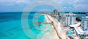 Flying over beautiful Cancun beach area. Aerial view of luxury hotels
