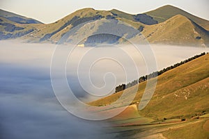 Flying over Castelluccio di Norcia, among ruins and bloom.