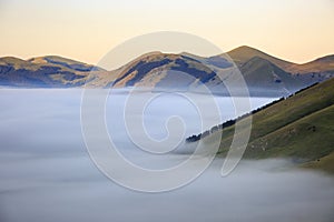 Flying over Castelluccio di Norcia, among ruins and bloom.