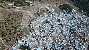 Flying over Chefchaouen and a blue city in Morocco with Drone from above (Aerial)