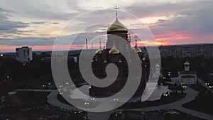 flying over the Church of the Kazan Icon of the Mother of God in Orenburg at a colorful sunset