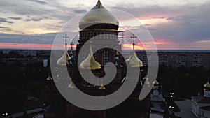 flying over the Church of the Kazan Icon of the Mother of God in Orenburg at a colorful sunset