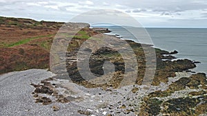 Flying over the coast at Penmon point lighthouse - Wales - United Kingdom