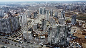 Flying over the construction site of a huge residential block of Chinese high-rise buildings. Construction of a modern