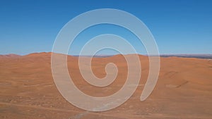 Flying over a Desert Dune near Village Merzouga in Morocco with Drone from above (Aerial)