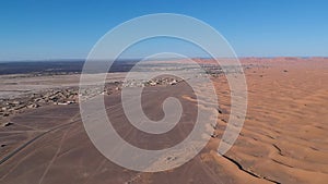 Flying over a Desert Dune near Village Merzouga in Morocco with Drone from above (Aerial)