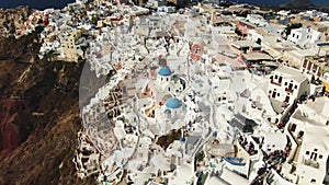 Flying Over Famous Blue Domed Church In Oia On Santorini Island In Greece