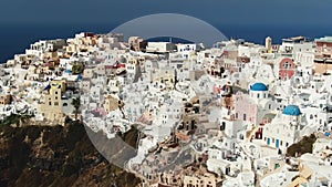 Flying Over Famous Blue Domed Church In Oia On Santorini Island In Greece
