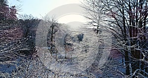 Flying over a farm in New England in the morning snow