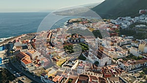 Flying over Garachico city center with colored houses. Aerial view of Old town of Garachico on island of Tenerife