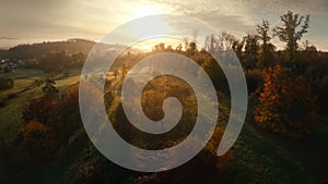 Flying over idyllic landscape towards the sun