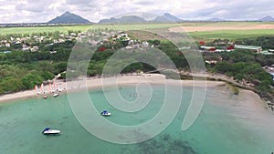 Flying over the Indian Ocean in Mauritius with luxury yacht and boats. Looking straight down to water. Albion area.