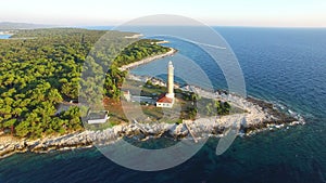 Flying over lighthouse, Croatia with a motorboat passing by