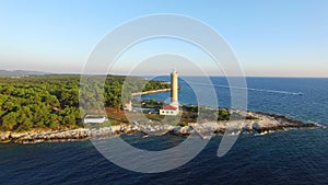 Flying over lighthouse, Croatia with a motorboat passing by