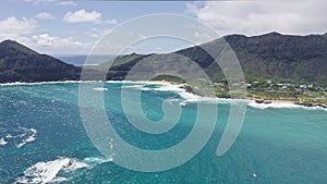 Flying over Makapuu Beach Park. Giant waves foaming and splashing in the ocean. The turquoise color of the Pacific Ocean