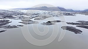 Flying over melting icebergs in Svinafellsjokull lake, Vatnajokull National Park, Iceland. Global warming envir