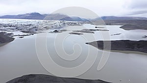 Flying over melting icebergs in Svinafellsjokull lake, Vatnajokull National Park, Iceland. Global warming envir