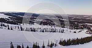 Flying over mountain, winter landscape, skiresort