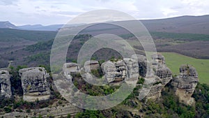 Flying over a natural impregnable mountain canyon. Ancient city fortress in rock