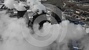 Flying over the plant producing thermal energy with large pipes. Aerial shot. Eclolgy problem concept.
