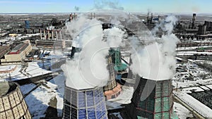 Flying over the plant producing thermal energy with large pipes. Aerial shot. Eclolgy problem concept.