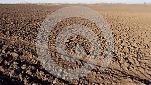 Flying over plowed fields of black soil on sunny autumn day. Fields black soil