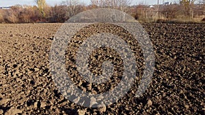 Flying over plowed fields of black soil on sunny autumn day. Fields black soil