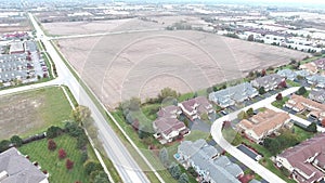 Flying over residential houses and yards along suburban street