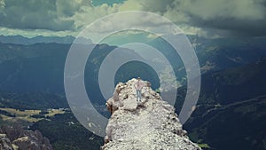 Flying over woman reaching the top of Piz Boe mountain in Italian Dolomites