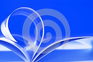 Flying pages on blue