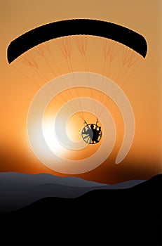 Flying paraglider silhouette at sunset